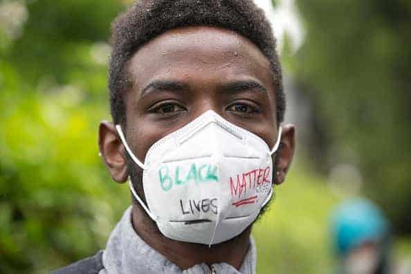 William Ngugi walks with others during a Black Lives Matter of Seattle-King County silent march on June 12