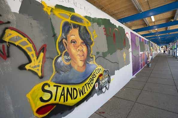 A mural for Breonna Taylor is painted on a construction fence near the White House in Washington