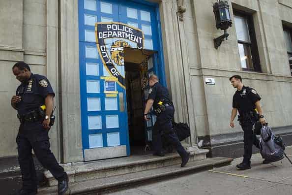 New York City Police Department (NYPD) officers enter the 1st Precinct in the Tribeca neighborhood of New York