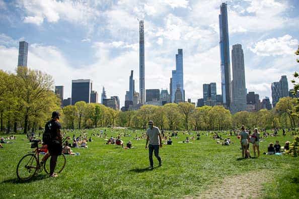 People wearing masks observe social distancing in Central Park as temperatures rise amid the coronavirus pandemic on May 3