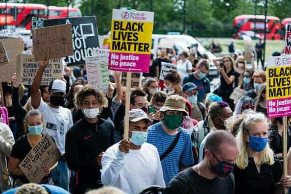 Protesters holding placards during a Black Lives Matter protest in London