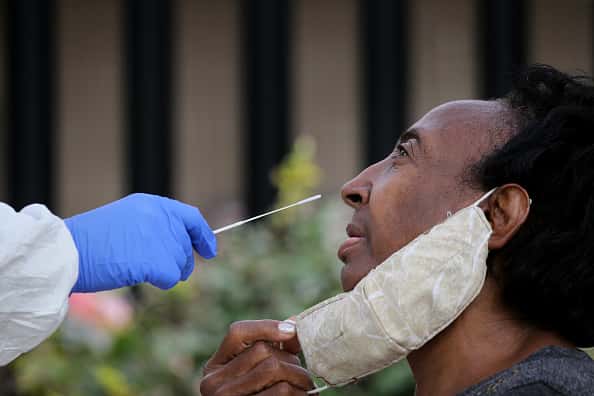 A person gets tested outside the Catherine Hardaway Residences in the Roxbury neighborhood of Boston