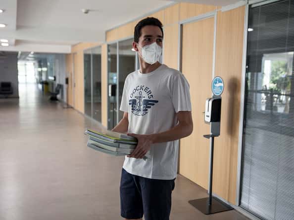 A student leaves his school after picking up his book on May 25