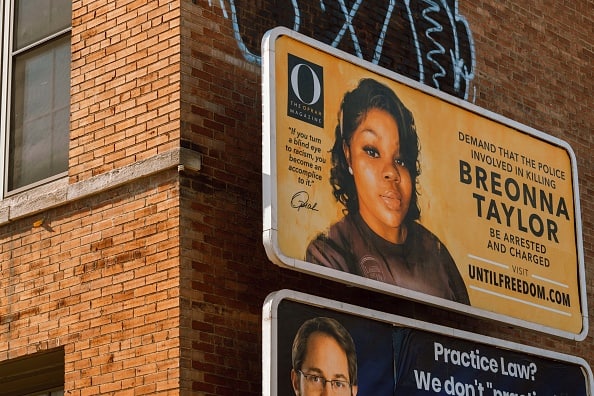 A billboard featuring a picture of Breonna Taylor and calling for the arrest of police officers involved in her death is seen on August 11