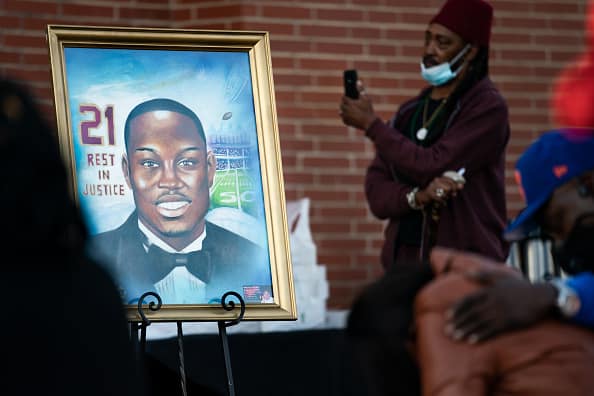 A painting of Ahmaud Arbery is displayed during a vigil at New Springfield Baptist Church on February 23