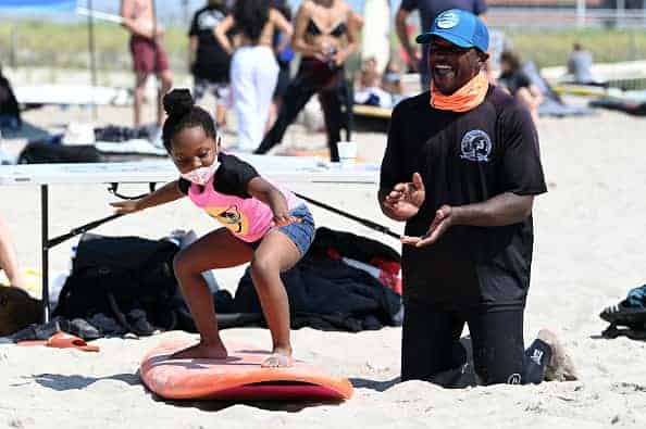 Surfers practice on the beach after the Black Lives Matter Paddle Out on June 20
