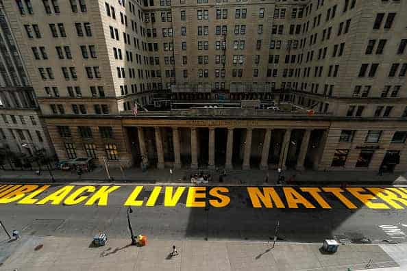 A mural reading “Black Lives Matter” in large yellow letters was added to the street in front of the Brooklyn Municipal Building on June 30