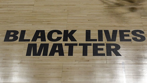 General view of the shadow of a player dribbling a ball on the court past the Black Lives Matter sign on the court during the second half of the game between the Atlanta Dream and the Minnesota Lynx at Feld Entertainment Center on August 23