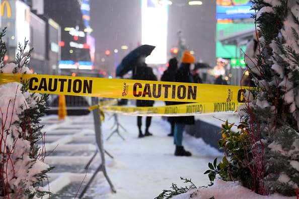 A caution tape is seen during a snow storm in Times Square on December 16
