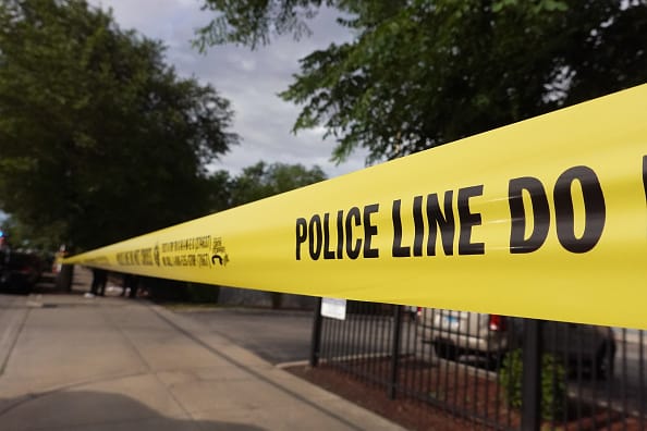 Police tape surrounds a crime scene where three people were shot at the Wentworth Gardens housing complex in the Bridgeport neighborhood on June 23