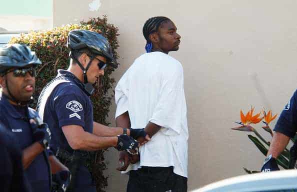 Police arrest a man after mounted police in riot gear