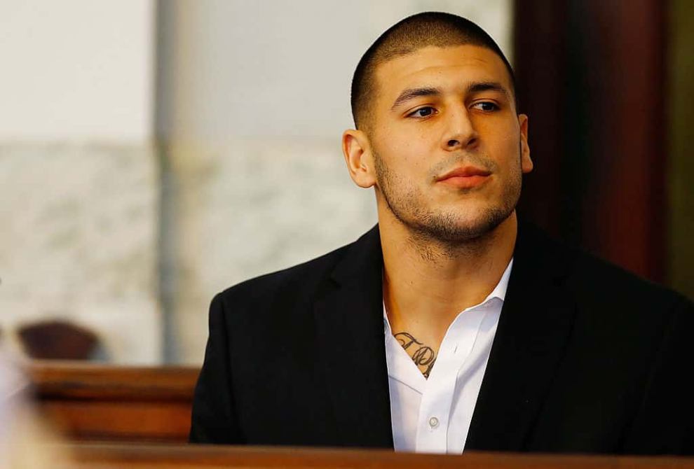 Aaron Hernandez wearing a black blazer and white shirt
