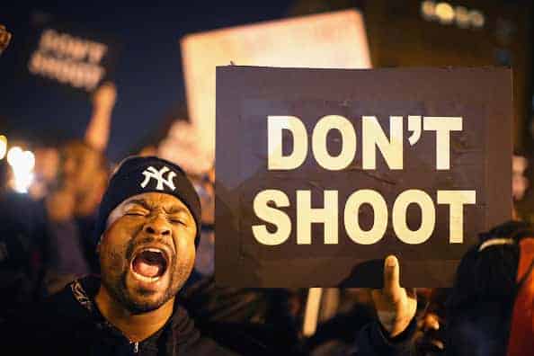 Demonstrators march through the streets protesting the October 8 killing of 18-year-old Vonderrit Myers Jr. by an off duty St. Louis police officer on October 9