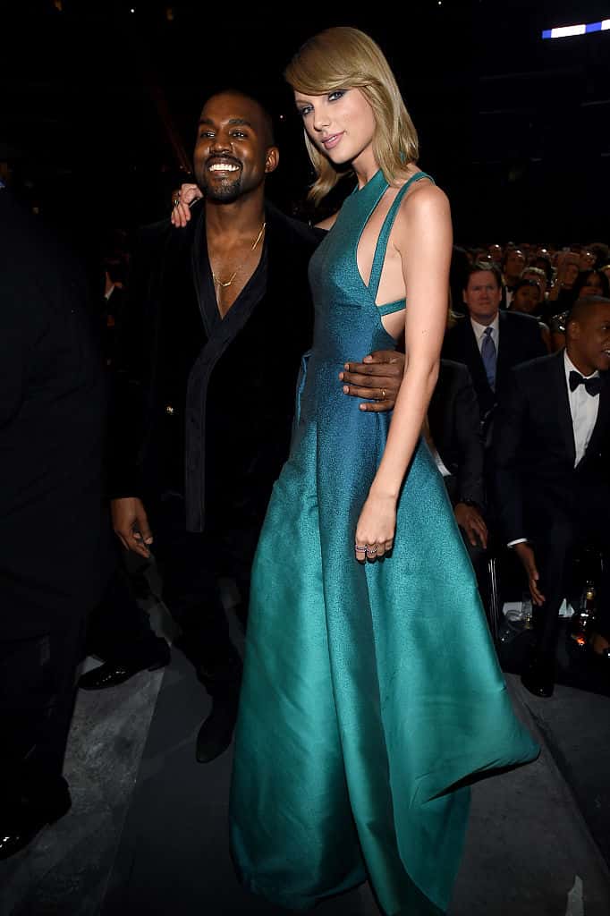 Kanye West and Taylor Swift standing next to each other wearing black and green