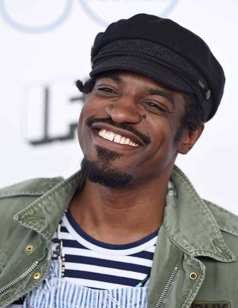 Rapper Andre 3000 smiling on the red carpet.