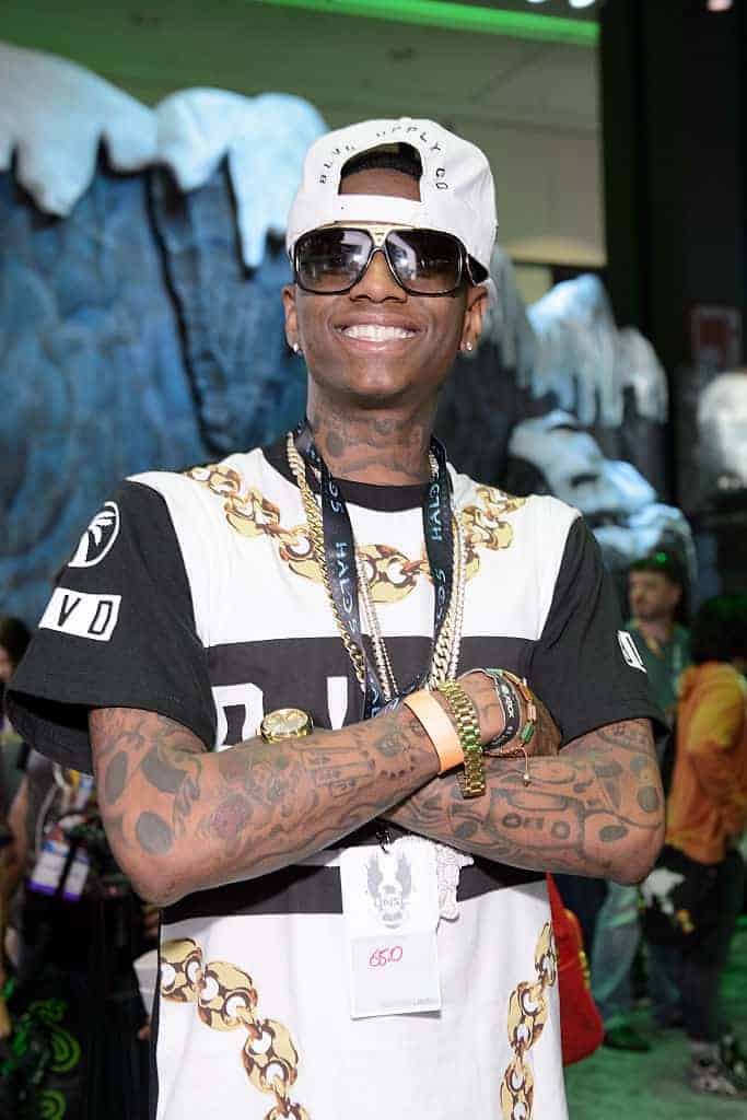 Soulja Boy smiling and wearing sunglasses and hat