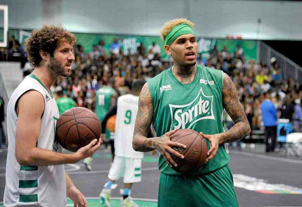 Lil Dicky and recording artist Chris Brown participate in the celebrity basketball game during the 2015 BET Experience