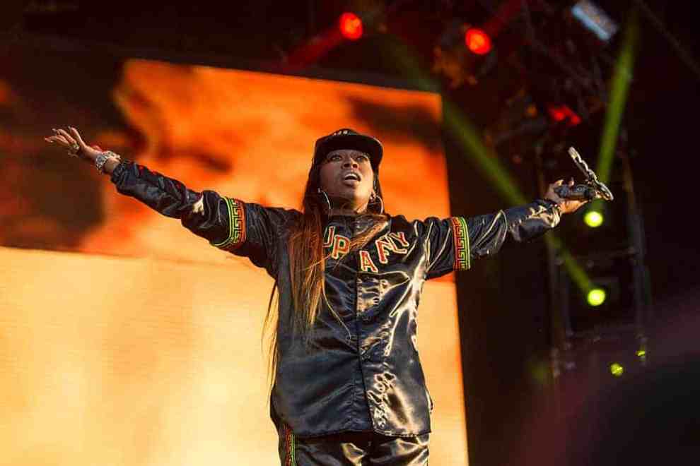 Missy Elliott standing on stage with her arms opened wide