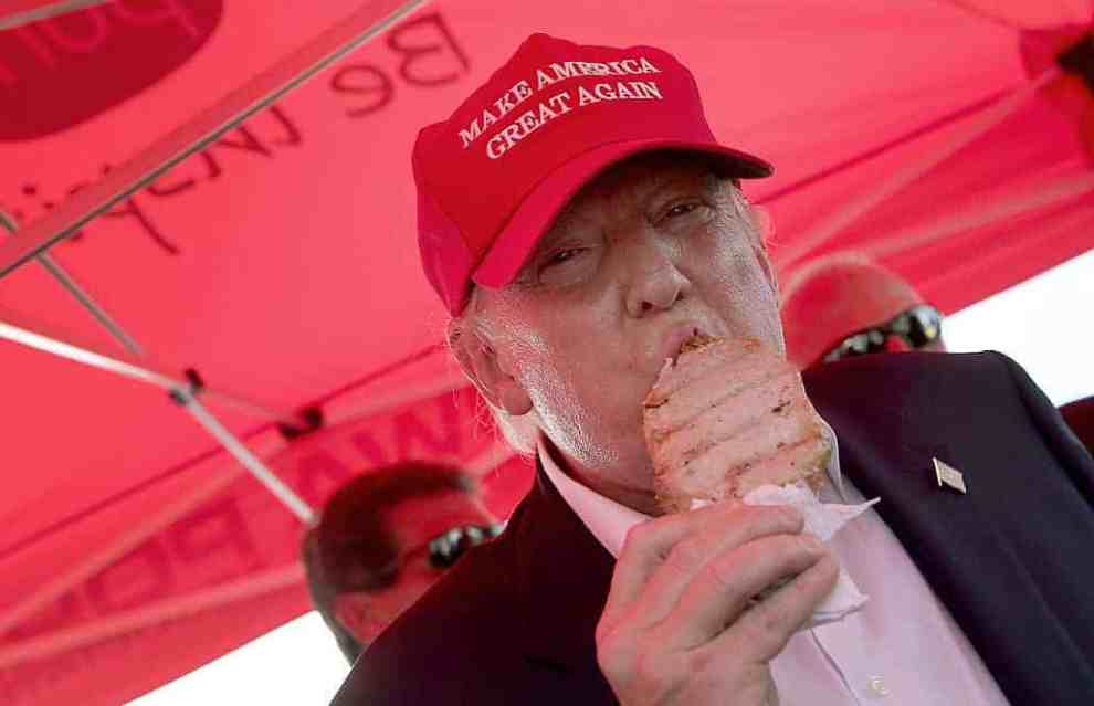 epublican presidential candidate Donald Trump eats a pork chop on a stick and gives a thumbs up sign to fairgoers at the Iowa St