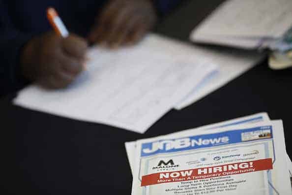 A job seeker fills out an application during a Job News USA career fair at Papa John's Cardinal Stadium in Louisville