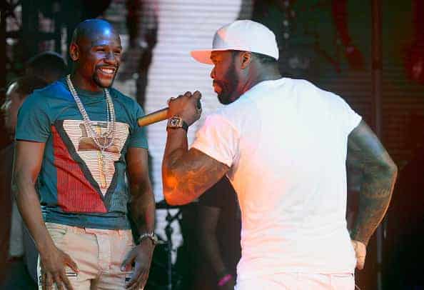 Boxer Floyd Mayweather Jr. (L) appears onstage with rapper 50 Cent as 50 Cent performs during the official Billboard Music Award