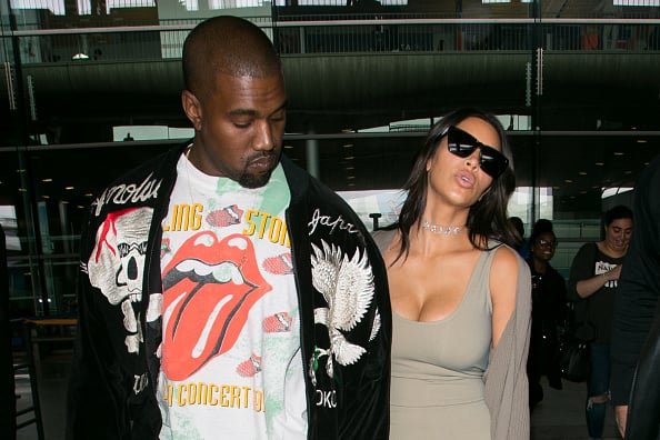 Kanye West and wife Kim Kardashian West arrive at Charles-de-Gaulle airport on June 13