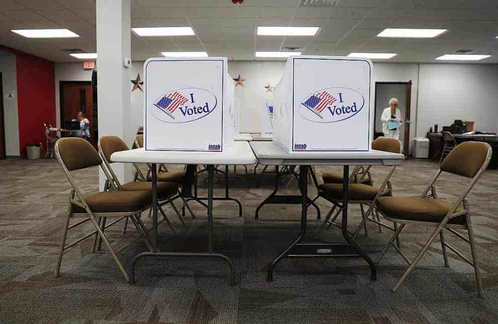 Voting booths on tables with chairs