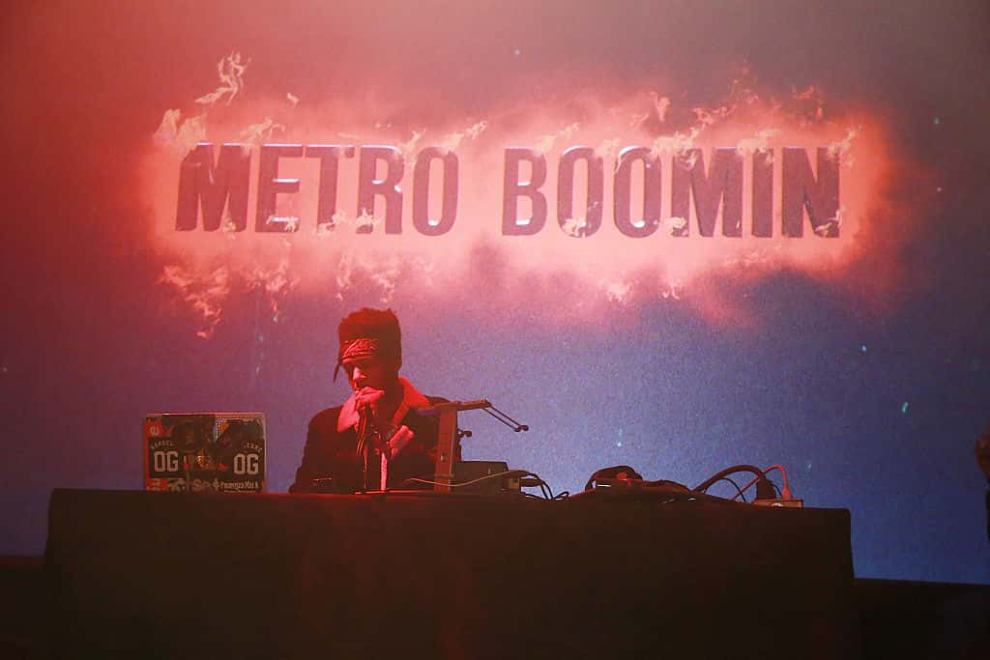 Metro Booming in front of Metro Booming sign