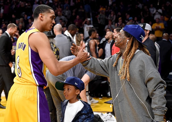 Rapper Lil Wayne shakes hands with Jordan Clarkson #6 of the Los Angeles Lakers during a during a 125-118 Laker win over the Brooklyn Nets at Staples Center on November 15