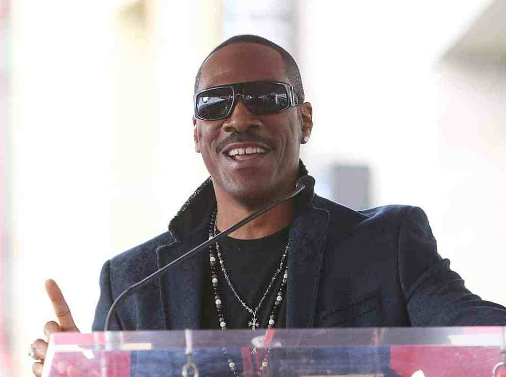 Eddie Murphy wearing black sunglasses and black jacket