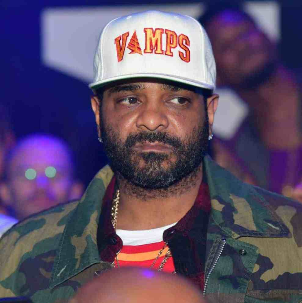 Jim Jones wearing a white and orange hat and camo jacket