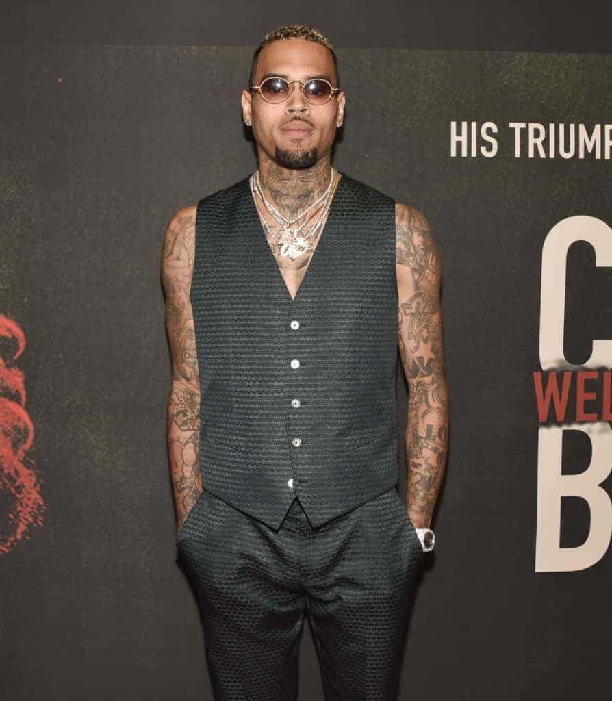 Chris Brown wearing all black and sunglasses
