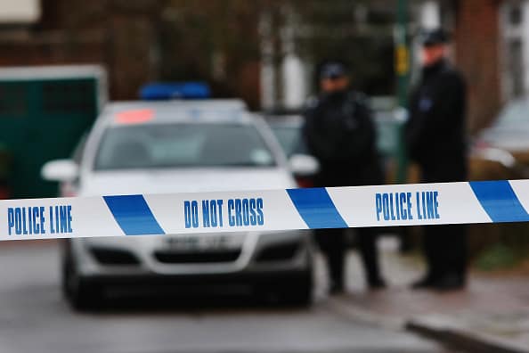 LONDON - DECEMBER 27: Police tape is pictured as police officers stand guard outside of a house in Edgeware on December 27