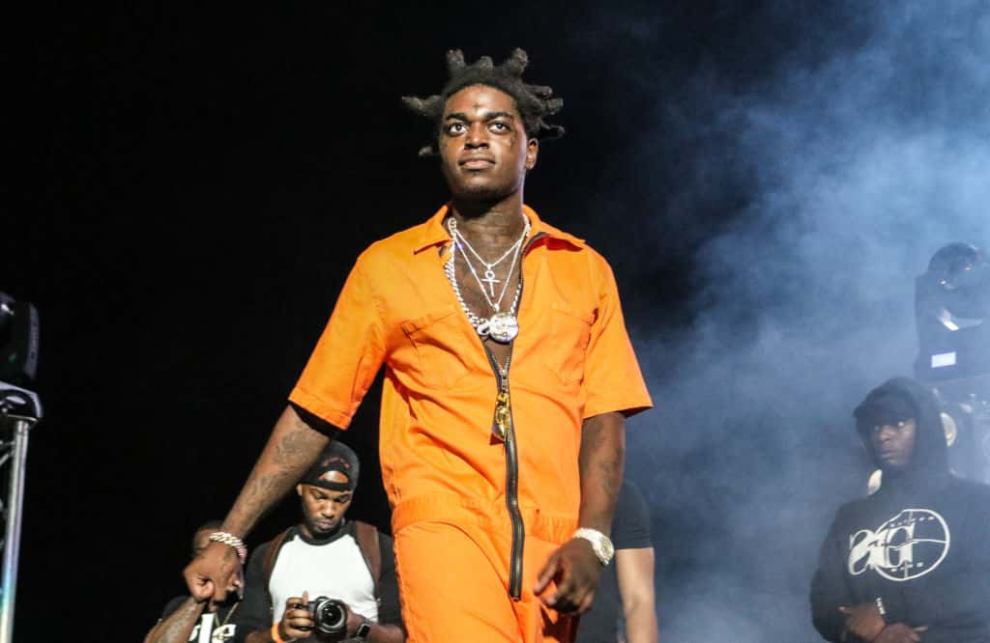 Kodak Black wearing an orange jumpsuit