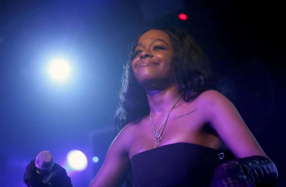 Azealia Banks performs at concert in Istanbul wearing black sleeveless gown and long black gloves