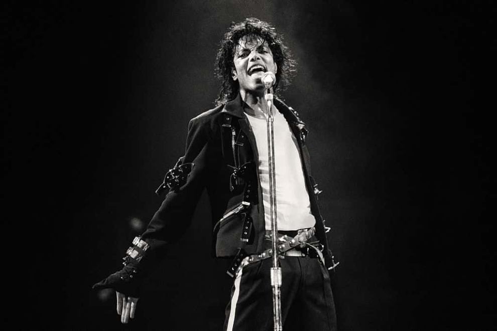 Black and white photo of Michael Jackson on stage performing