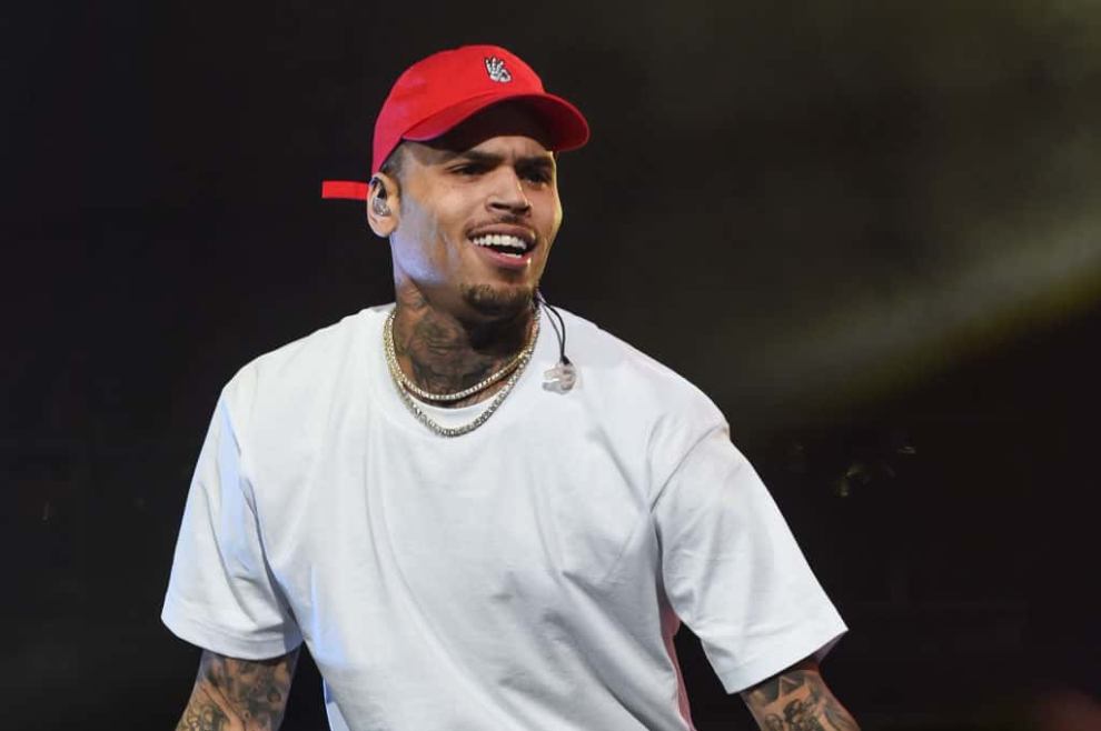 Chris Brown wearing a white shirt and red hat