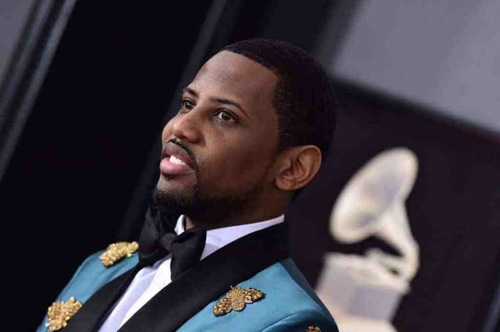 Fabolous wearing a blue jacket and black tie