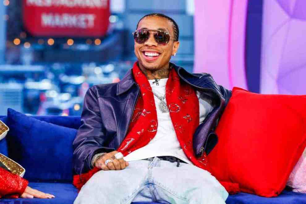 Tyga lounges on a couch
