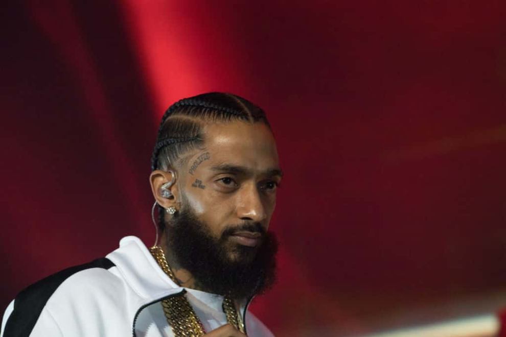 Nipsey Hussle wearing white sweatsuit
