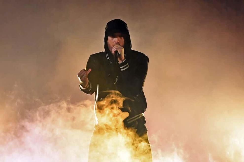 Eminem  performing on a stage filled with smoke