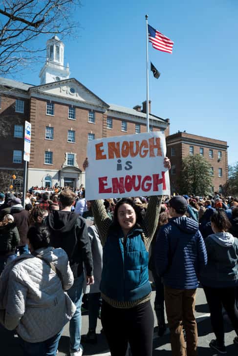 Gun control protesters holding sign "Enough is Enough"