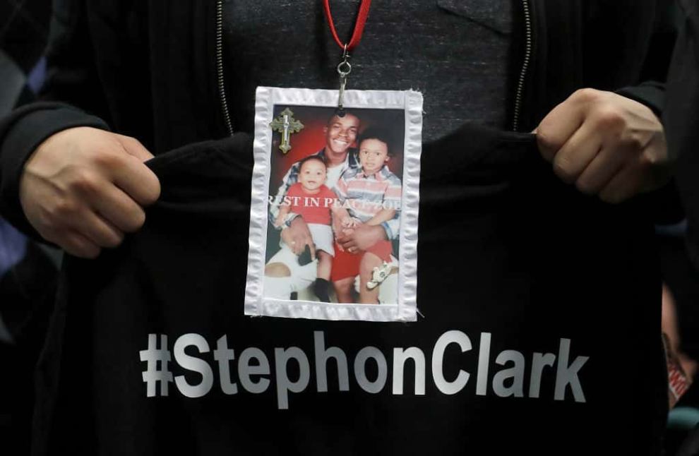A mourner holds up a photo of police shooting victim Stephon Clark during the funeral services for Clark at Bayside Of South Sac