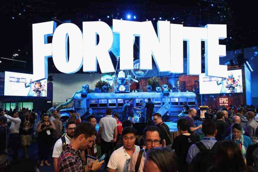 FortNite Sign with a crowd of people in front of it.