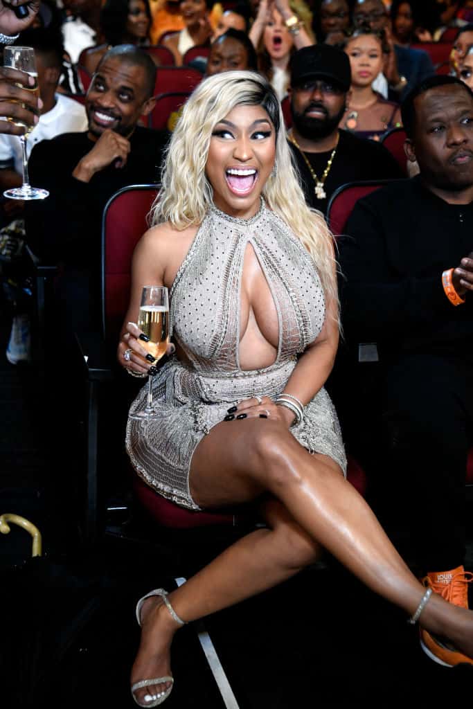 Nicki Minaj in audience with a glass of champagne in her hand