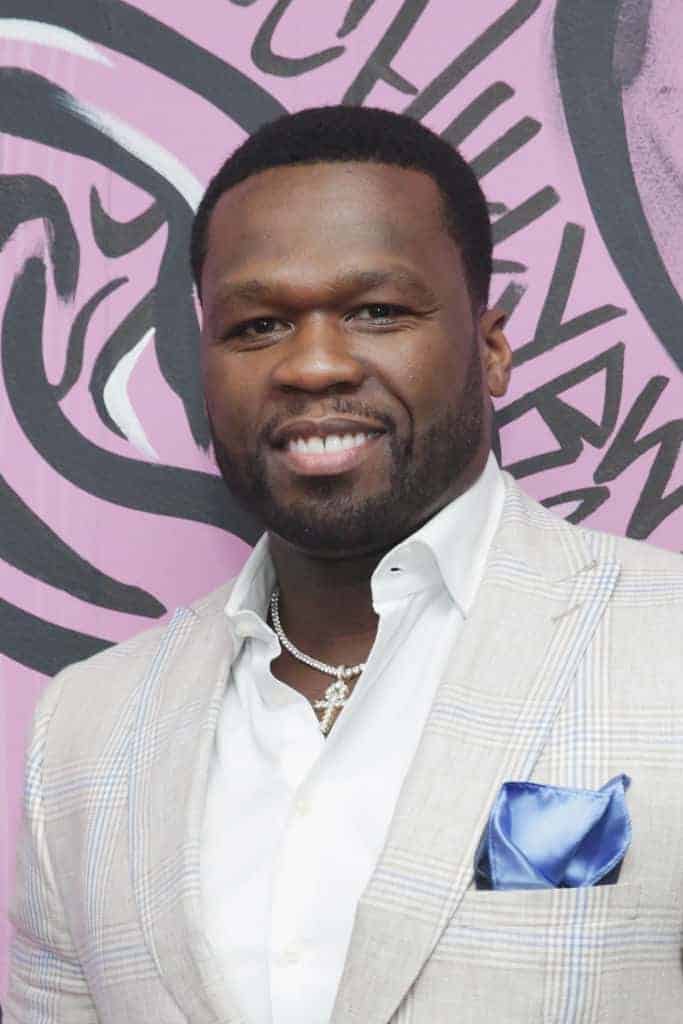 50 cent wearing a tux and smile at the camera