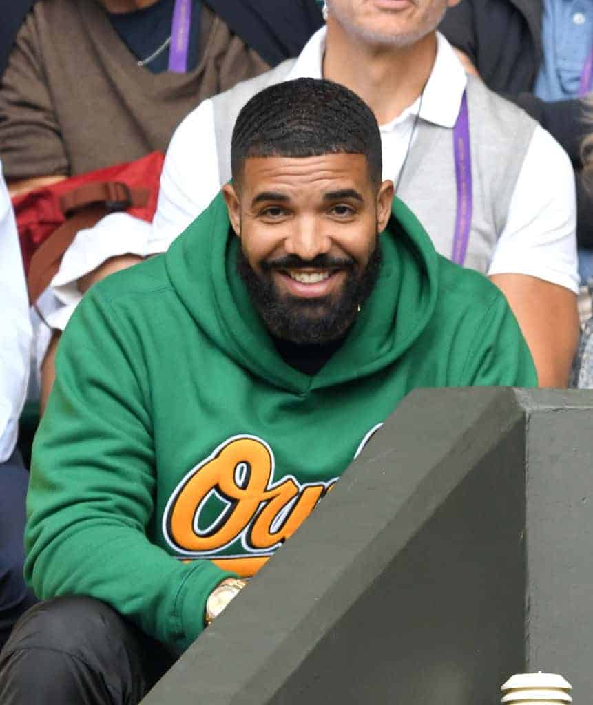 Drake attending game in green owl sweatshirt
