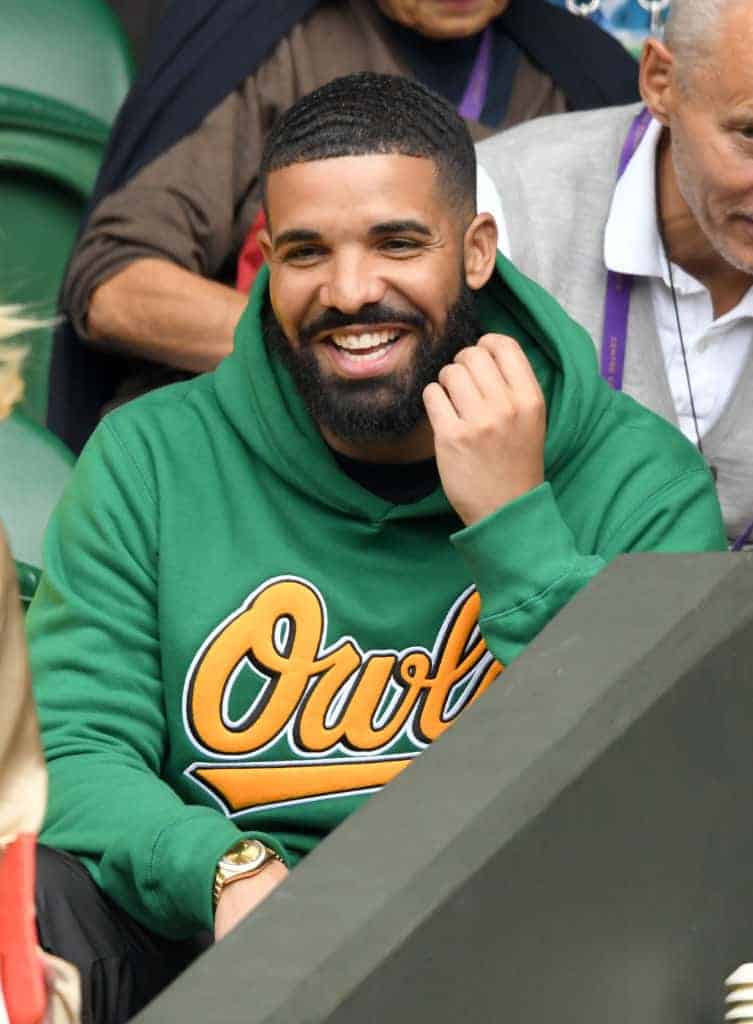 Drake attending game in green owl sweatshirt