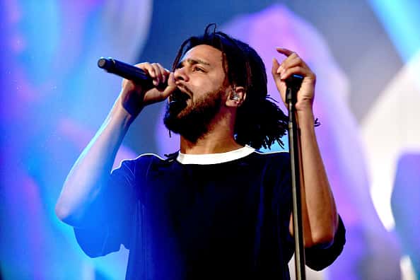 Jcole performing at a concert.