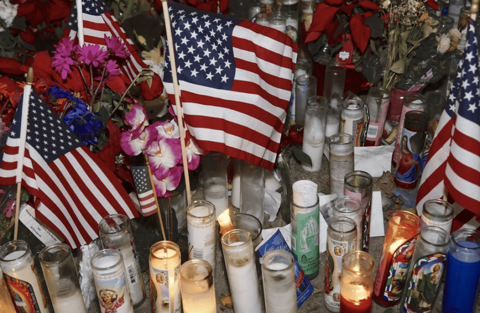 American flag with candles for a mass shooting